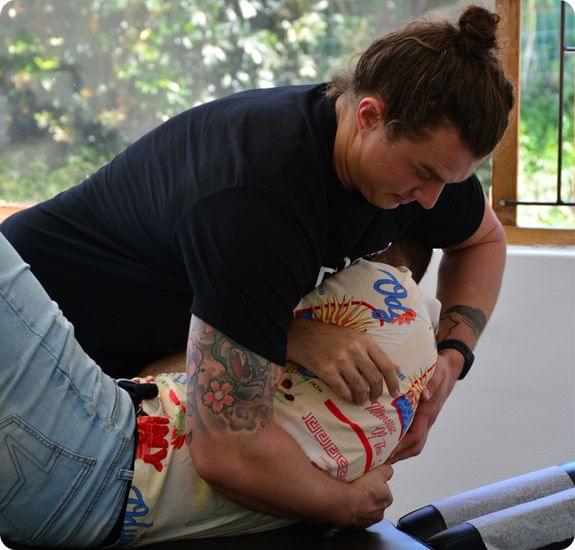 A chiropractitioner displaying Chiropractic Adjustments