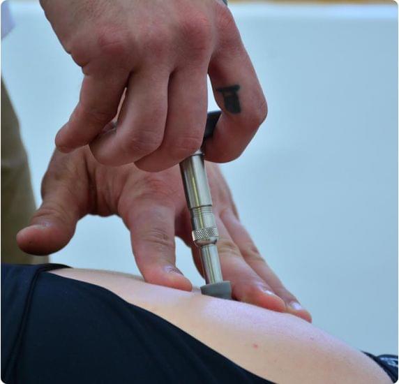 A chiropractitioner displaying activator Adjustments