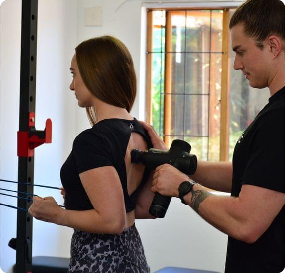 A chiropractitioner displaying Percussion Therapy