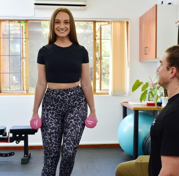a woman holding balancing with weights guided by Dr. Matt